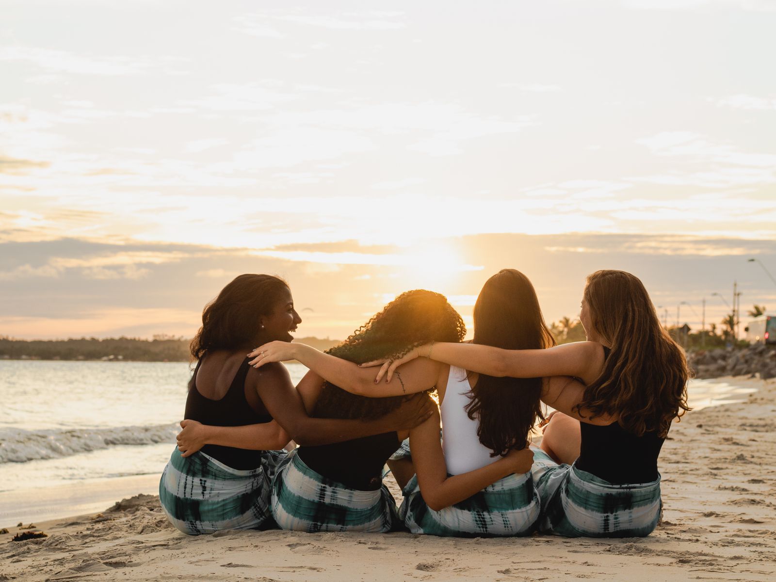 Women in quiet connection on the beach